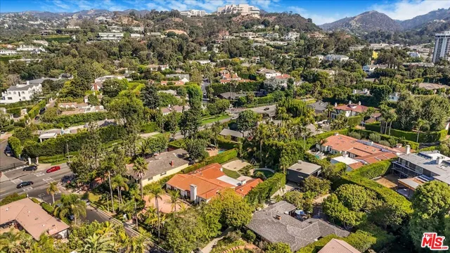 an aerial view of residential building with green space