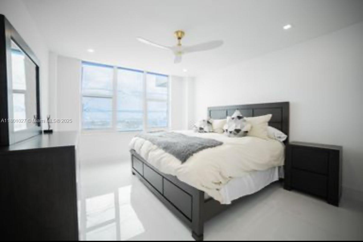 5600 Collins Avenue, Unit 14K Miami Beach, FL 33140 - Photo 11 of 27 a bedroom with a bed and window