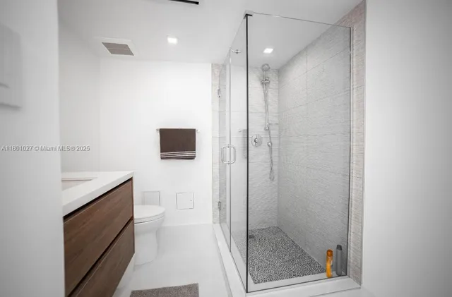 a bathroom with a shower and a sink