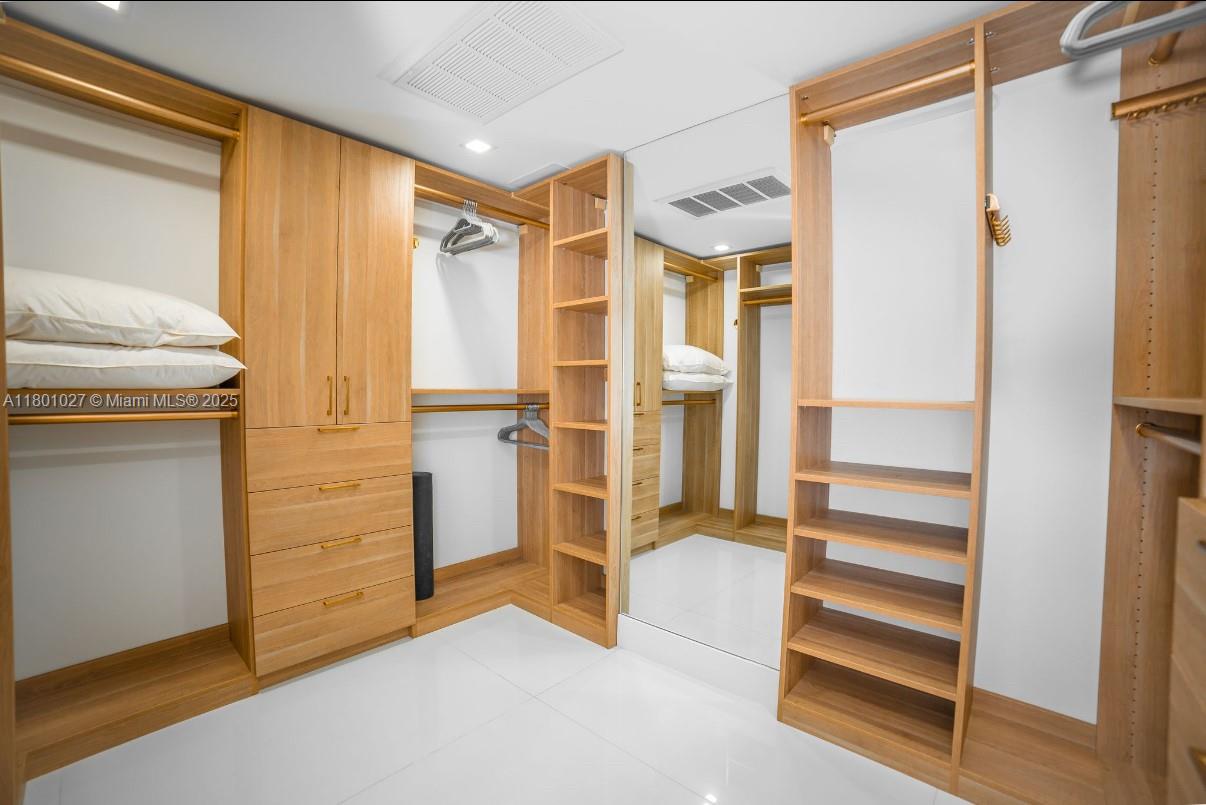 5600 Collins Avenue, Unit 14K Miami Beach, FL 33140 - Photo 15 of 27 a view of walk in closet with empty racks