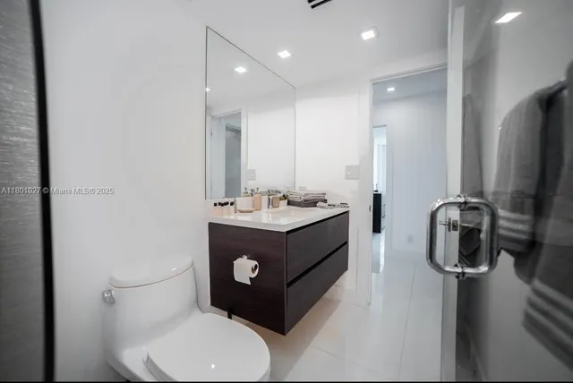 a bathroom with a toilet sink and mirror