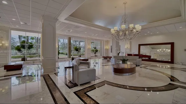 a living room with fireplace furniture and a chandelier