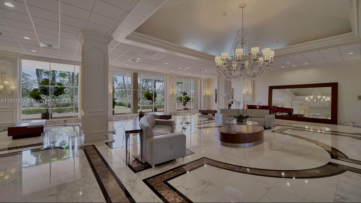 5600 Collins Avenue, Unit 14K Miami Beach, FL 33140 - Photo 27 of 27 a living room with fireplace furniture and a chandelier