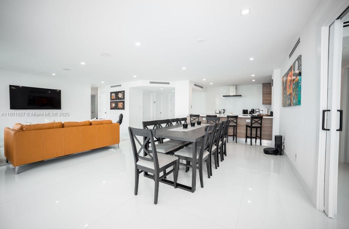5600 Collins Avenue, Unit 14K Miami Beach, FL 33140 - Photo 3 of 27 a view of a dining room with furniture