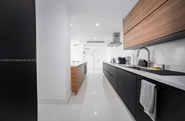 a kitchen with stainless steel appliances granite countertop a sink a stove and a refrigerator