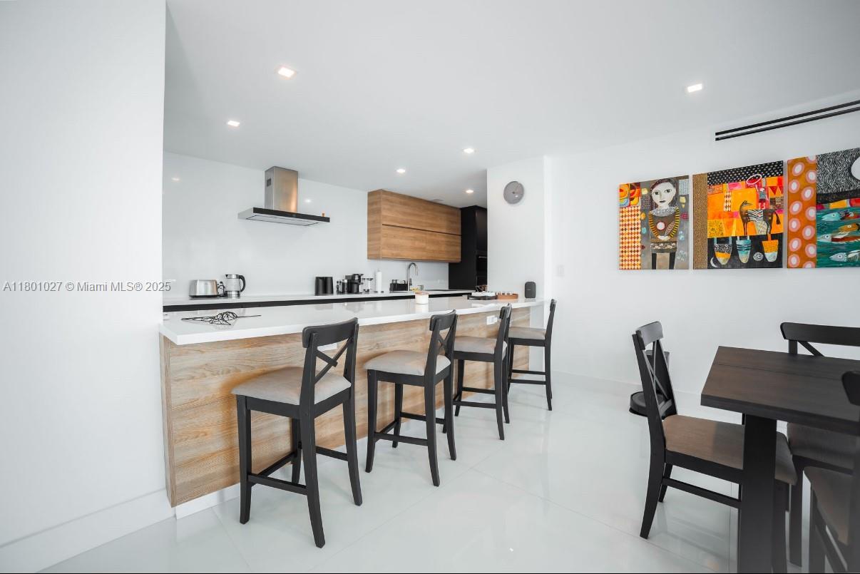 5600 Collins Avenue, Unit 14K Miami Beach, FL 33140 - Photo 7 of 27 a dining room with furniture and window