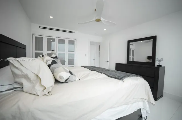 a large white bed in a white room