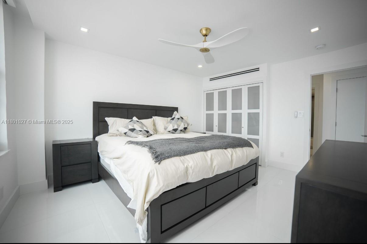5600 Collins Avenue, Unit 14K Miami Beach, FL 33140 - Photo 10 of 27 a bedroom with a bed and a window