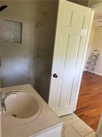 a view of a room with wooden floor and small window