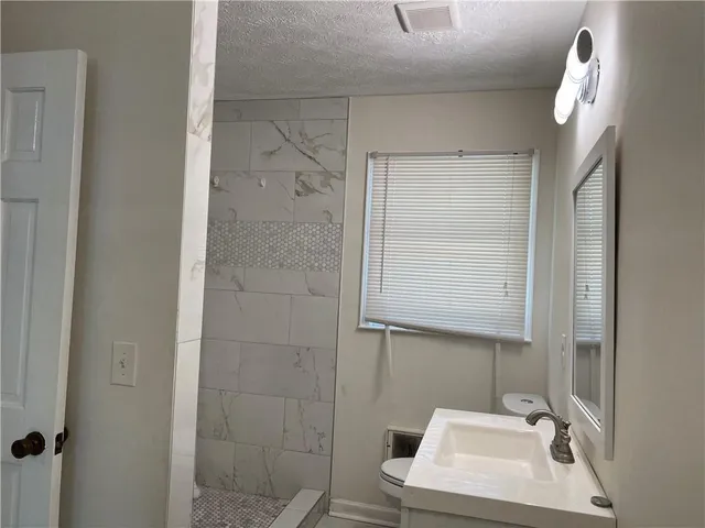 a bathroom with a bathtub sink and toilet