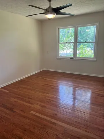 a view of a livingroom with wooden floor and a window