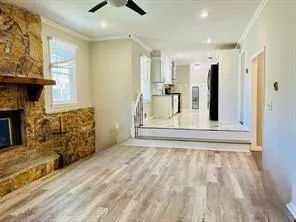 wooden floor in an empty room with a fireplace