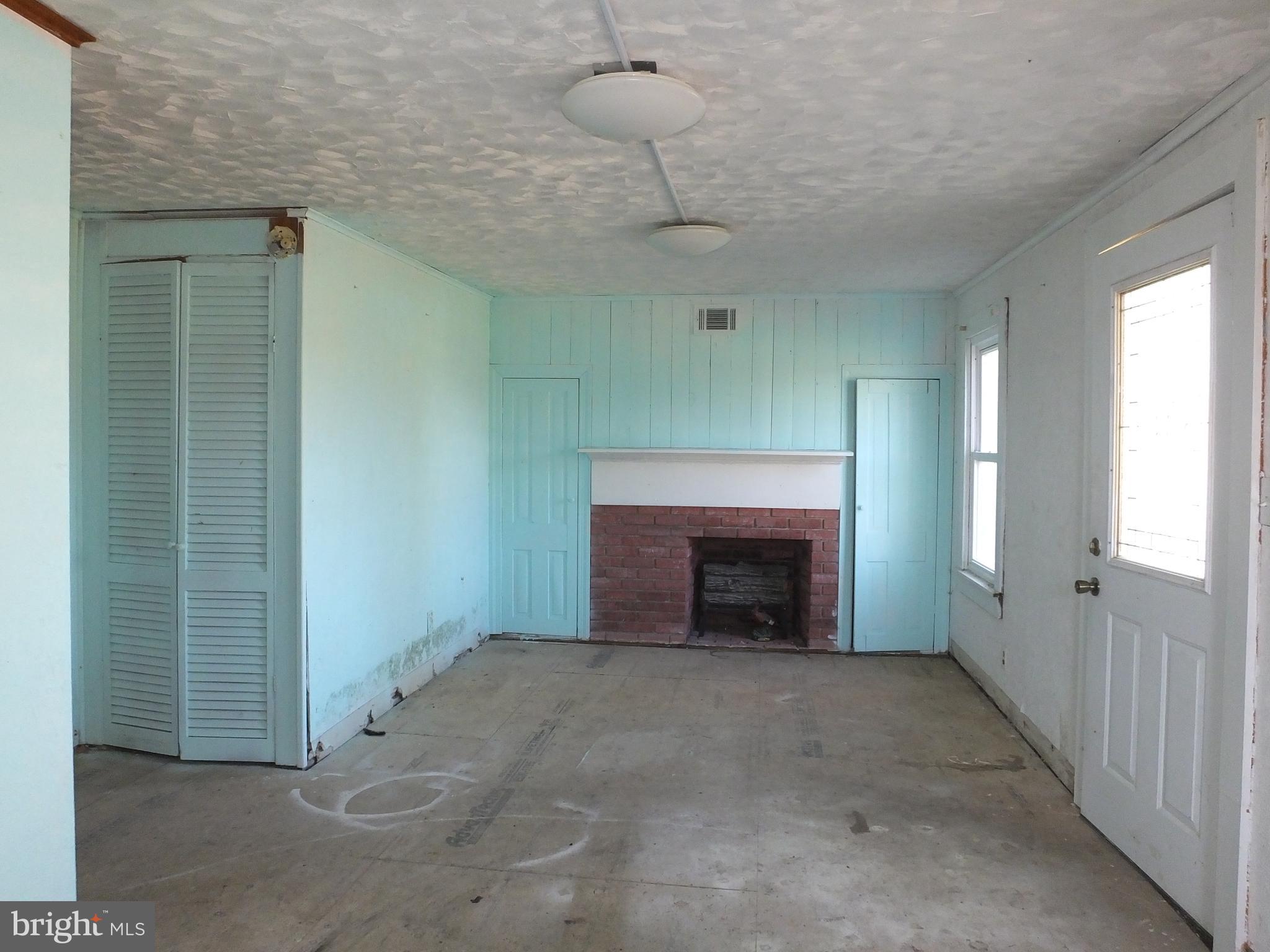 1213 Horse Point Road Fishing Creek, MD 21634 - Photo 20 of 23 a view of an empty room with a fireplace and a window