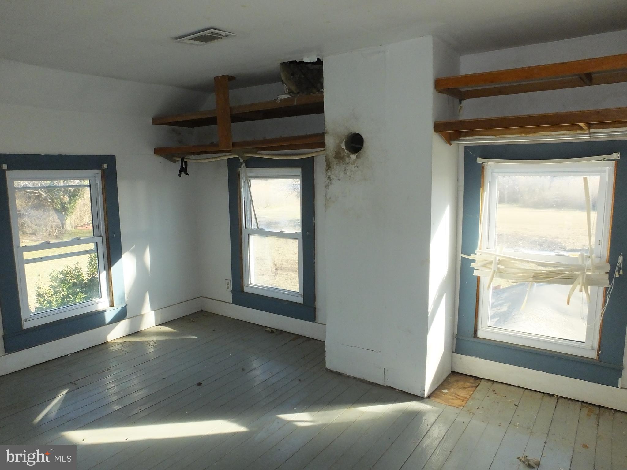 1213 Horse Point Road Fishing Creek, MD 21634 - Photo 21 of 23 an empty room with wooden floor and windows