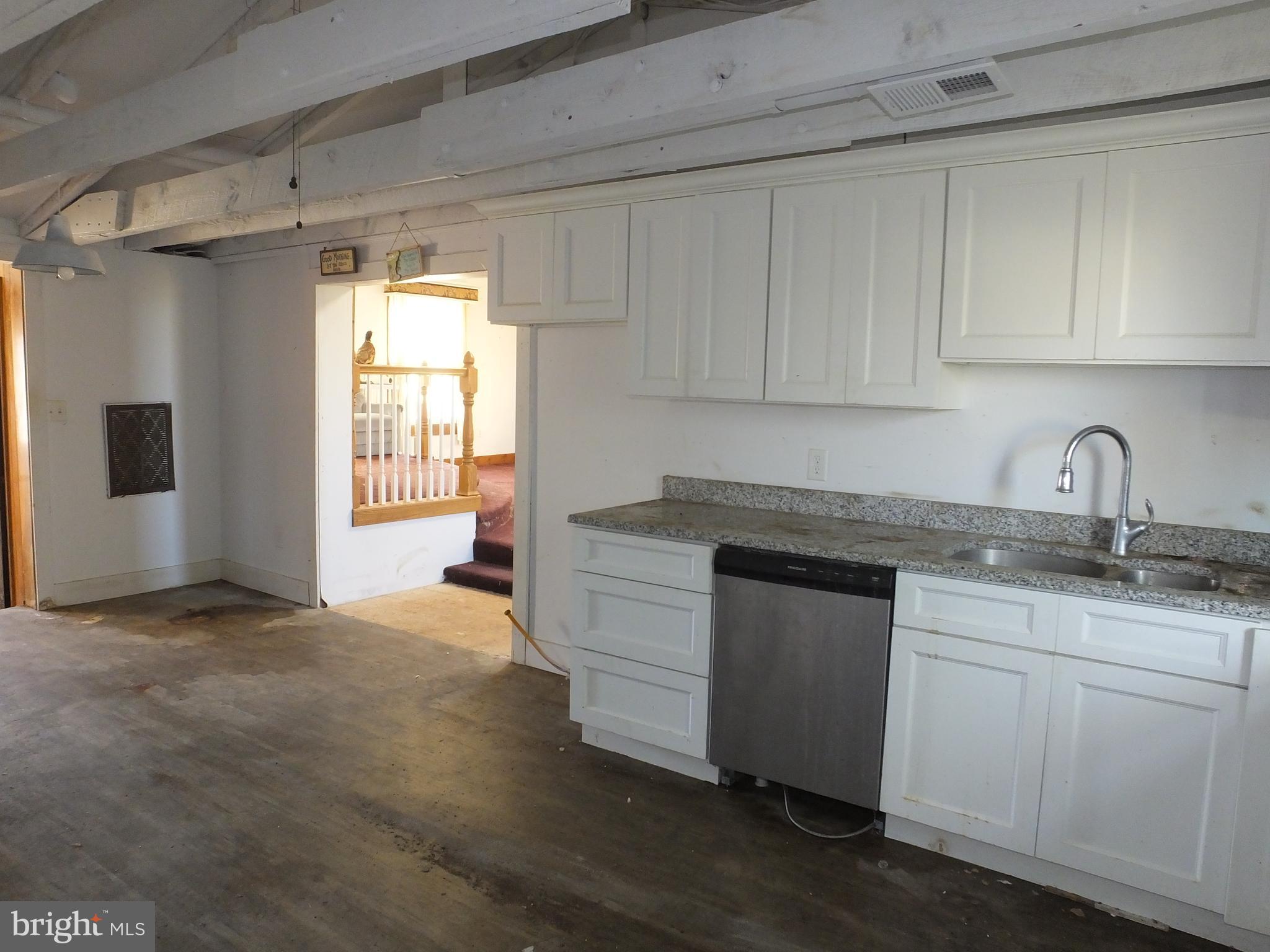 1213 Horse Point Road Fishing Creek, MD 21634 - Photo 23 of 23 a kitchen with granite countertop white cabinets and white appliances