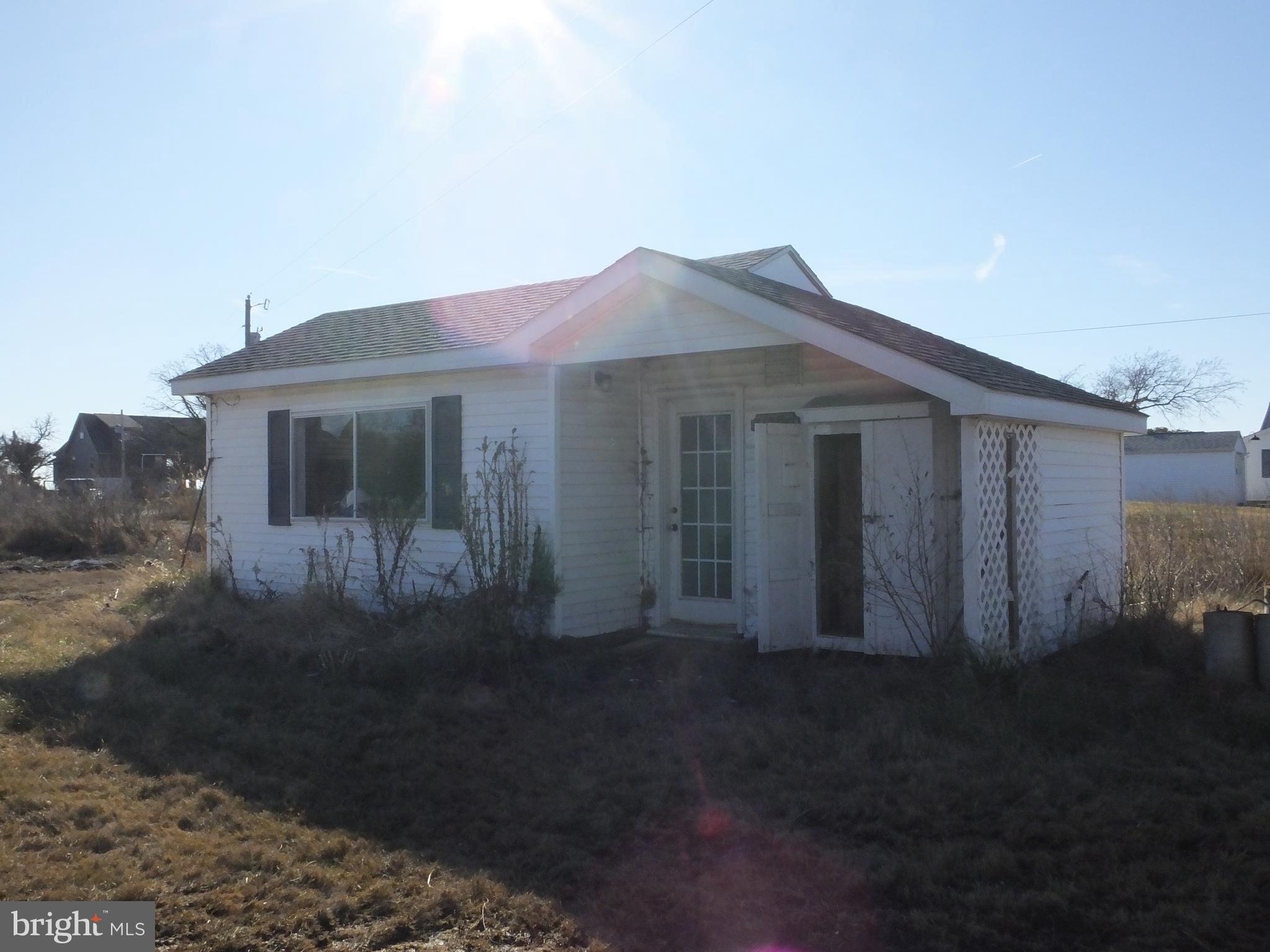 1213 Horse Point Road Fishing Creek, MD 21634 - Photo 5 of 23 a front view of a house with a yard
