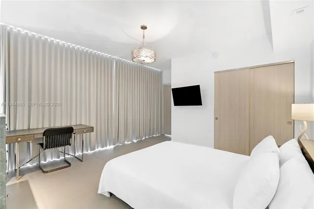 a bedroom with a bed and a chair