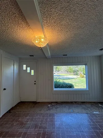 a view of a livingroom with furniture and a window