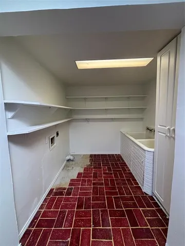 a kitchen with a sink and a stove top oven
