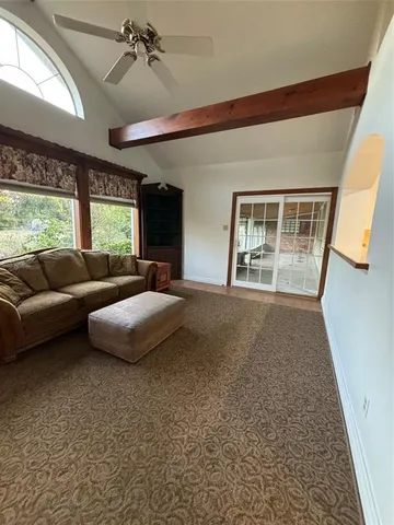 a bedroom with furniture and a large window