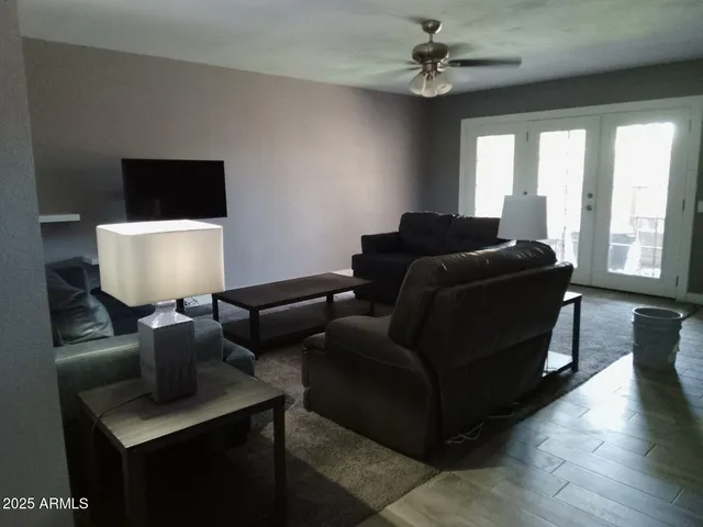 a living room with furniture and a piano