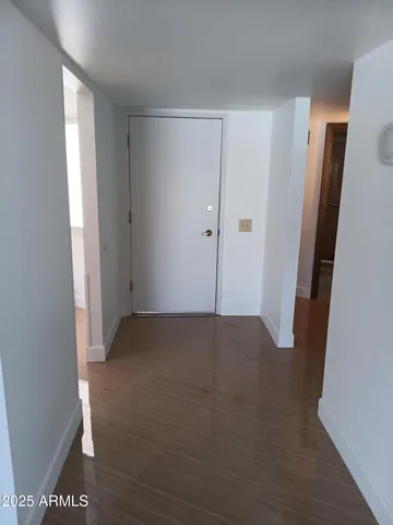 a view of a room with wooden floor and white walls