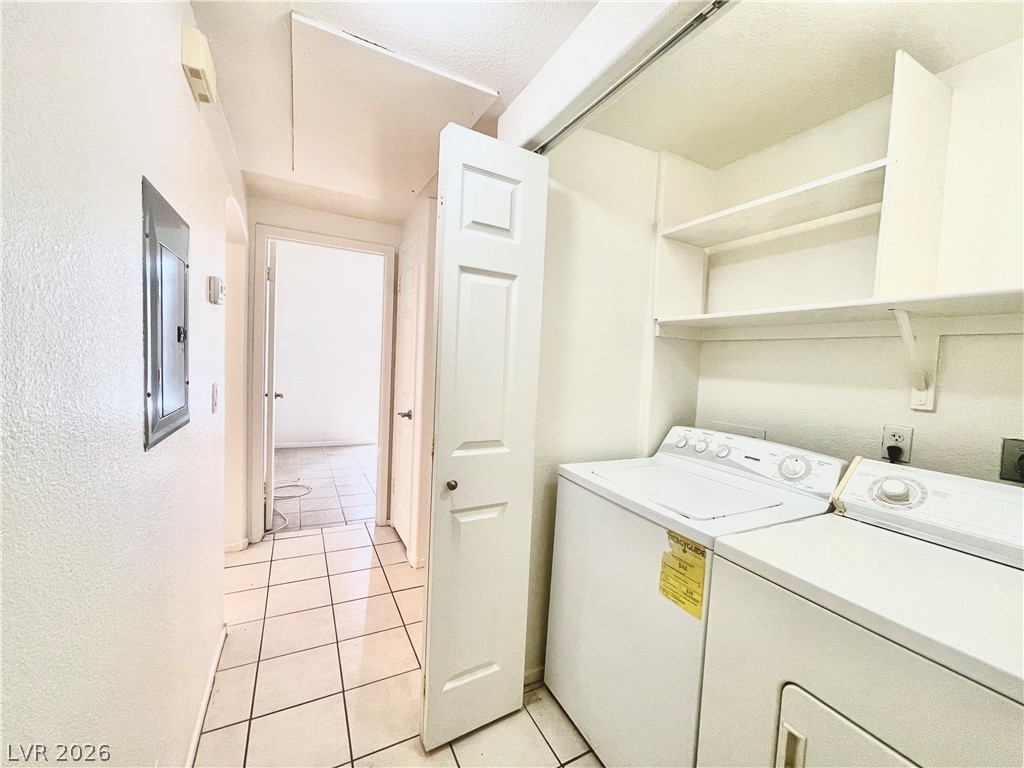 2201 Ramsgate Drive, Unit 915 Henderson, NV 89074 - Photo 25 of 36 A dedicated utility space with a washer, dryer, and convenient storage shelves.
