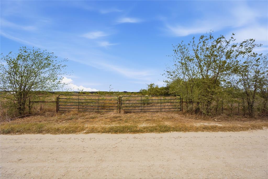 0 Northeast CR 1060 Rice, TX 75155 - Photo 26 of 30 Expansive open land featuring an entry gate, natural vegetation, and a clear sky