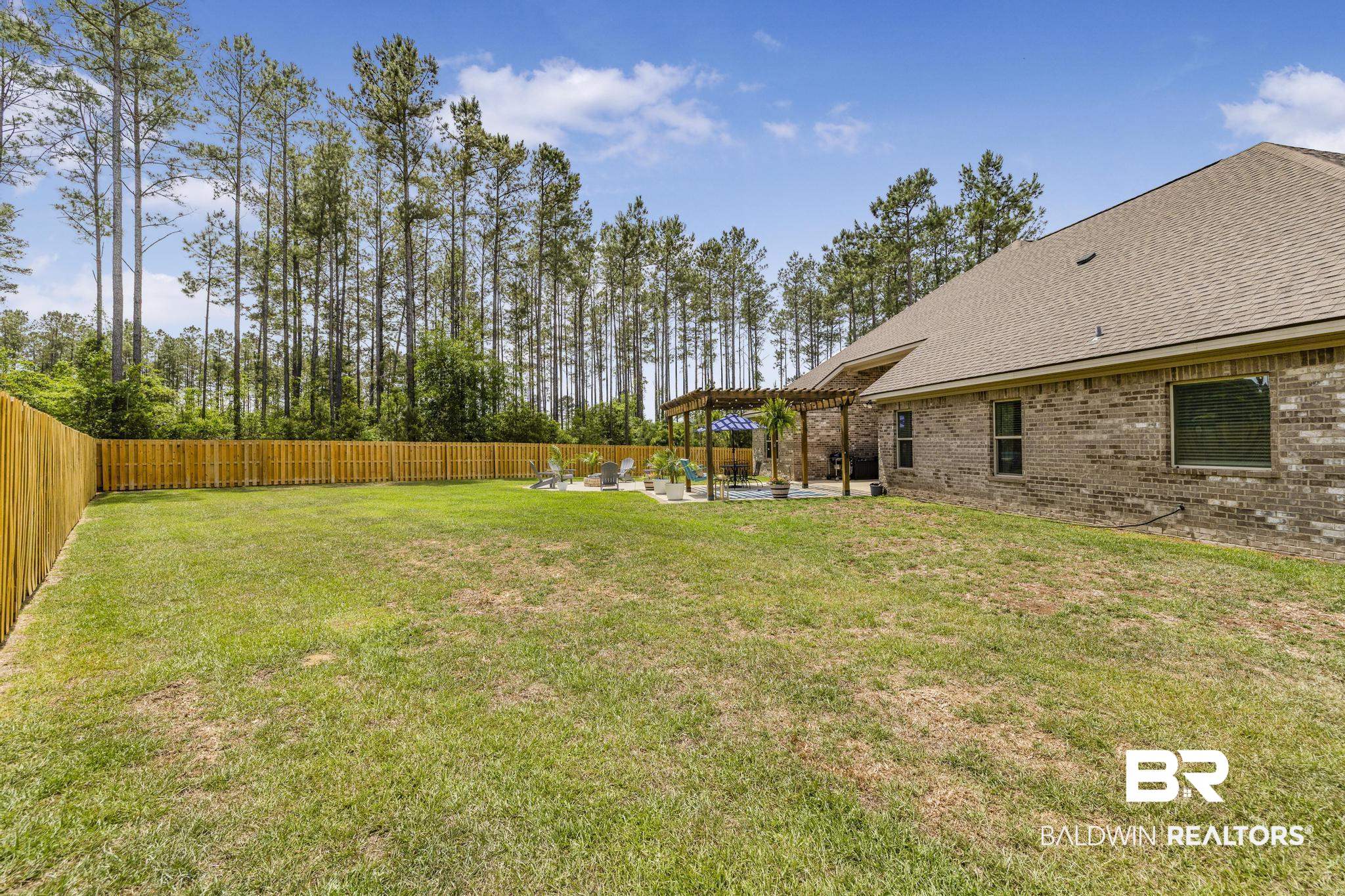 31806 Bobwhite Road Daphne, AL 36527 - Photo 40 of 59 Fenced backyard featuring a pergola and a patio area