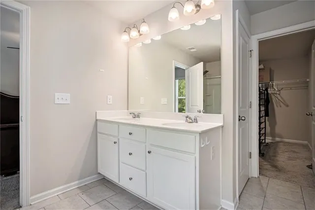 a bathroom with a double vanity sink mirror and shower