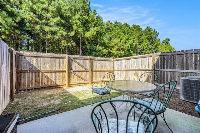 a view of a wooden deck and a backyard