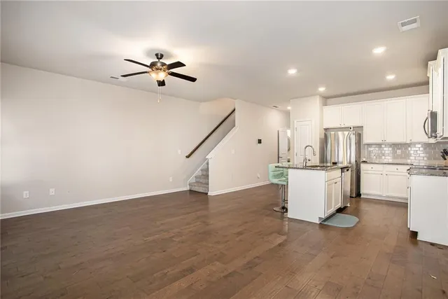 a view of kitchen with furniture and a ceiling fan