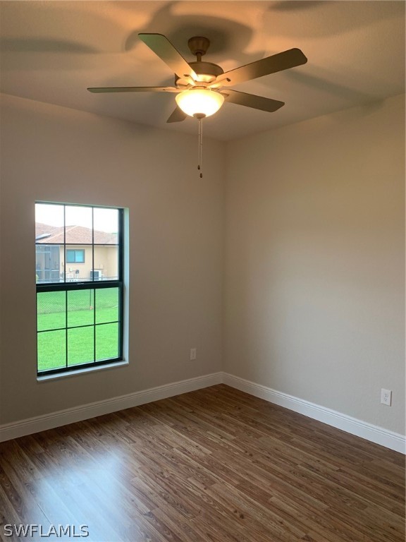 130 Southwest 37th Avenue Cape Coral, FL 33991 - Photo 13 of 30 an empty room with wooden floor and windows