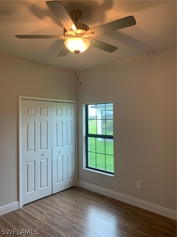 130 Southwest 37th Avenue Cape Coral, FL 33991 - Photo 14 of 30 an empty room with wooden floor fan and windows