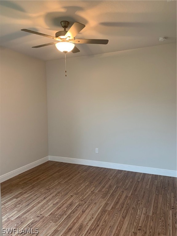 130 Southwest 37th Avenue Cape Coral, FL 33991 - Photo 15 of 30 a view of a room with wooden floor and a ceiling fan