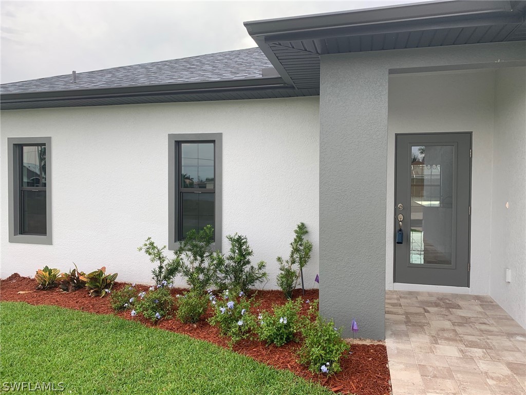 130 Southwest 37th Avenue Cape Coral, FL 33991 - Photo 2 of 30 a front view of a house with a yard