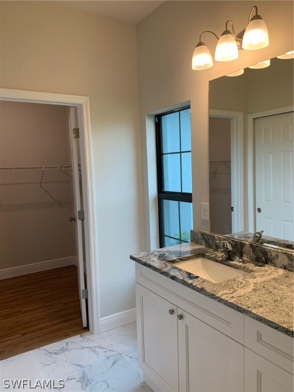 130 Southwest 37th Avenue Cape Coral, FL 33991 - Photo 25 of 30 a bathroom with a granite countertop sink and a mirror