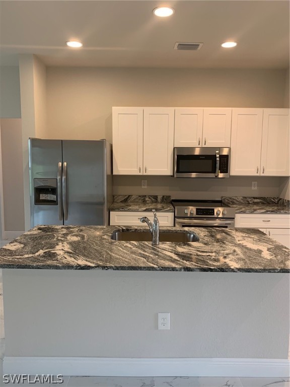 130 Southwest 37th Avenue Cape Coral, FL 33991 - Photo 3 of 30 a kitchen with stainless steel appliances granite countertop a sink a stove and a microwave