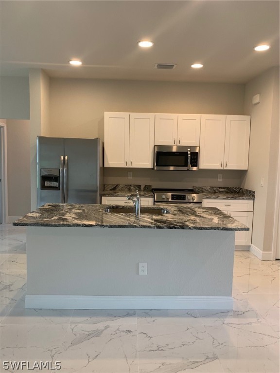 130 Southwest 37th Avenue Cape Coral, FL 33991 - Photo 4 of 30 a kitchen with stainless steel appliances granite countertop a sink a stove and a refrigerator