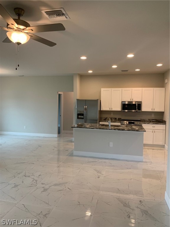 130 Southwest 37th Avenue Cape Coral, FL 33991 - Photo 6 of 30 a large kitchen with kitchen island a stove a refrigerator a sink and a stove