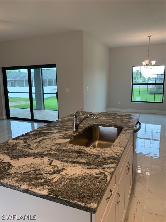 130 Southwest 37th Avenue Cape Coral, FL 33991 - Photo 7 of 30 a kitchen with a sink a counter top space cabinets and a window