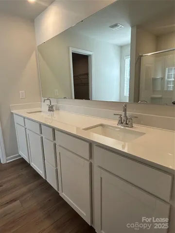 a bathroom with a double vanity sink and a mirror