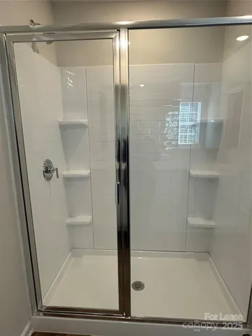 a bathroom with a glass shower door