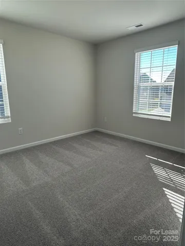 a view of an empty room with windows