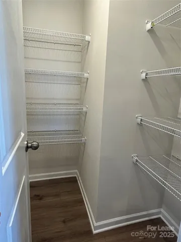 a view of a room with wooden floor and cabinet