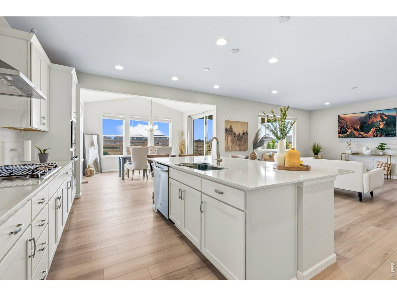 955 Rustling Street Windsor, CO 80550 - Photo 5 of 34 a kitchen with counter top space sink stove and wooden floor