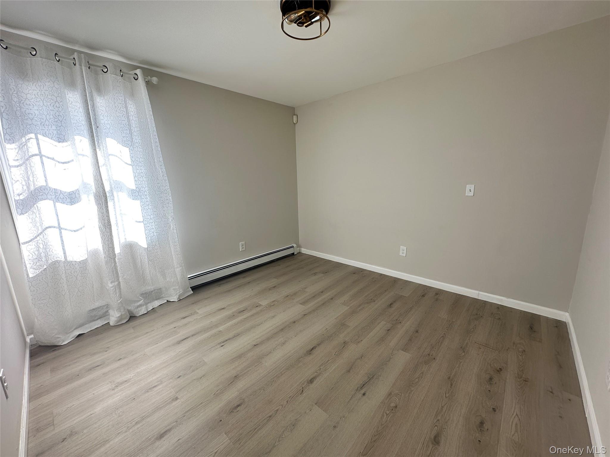 1241 Ridgebury Road New Hampton, NY 10958 - Photo 13 of 21 an empty room with wooden floor and windows