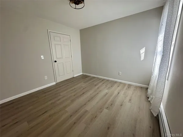 a view of a room with wooden floor