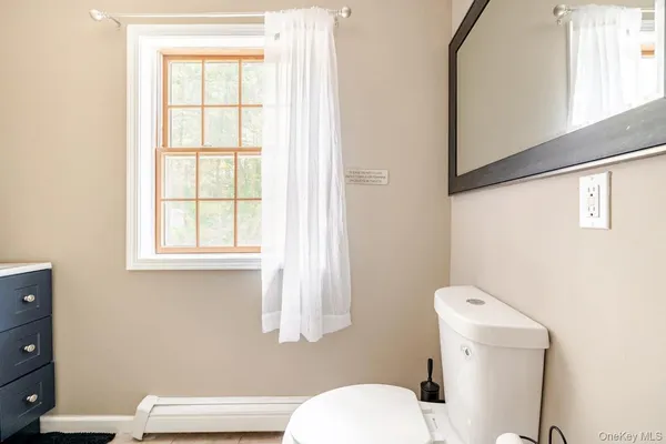 a white toilet sitting next to a bathroom sink