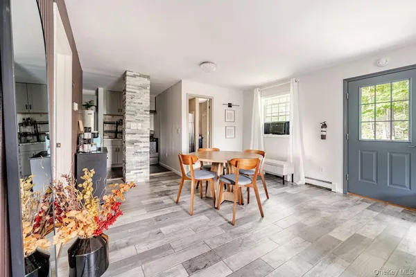a dining room filled with furniture and a chandelier